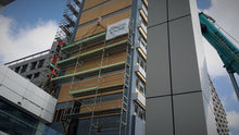 Load image into Gallery viewer, Scaffold being craned into position on Copthorne Refurbishment. Scaffolders safely standing to one side.
